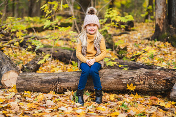 An Autumn portrait of cute blond child girl