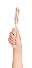 hand holding wood Hair comb isolated on a white background