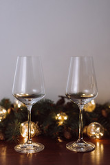 Christmas decoration with two glasses  and lights on a wooden background, Happy New Year. 