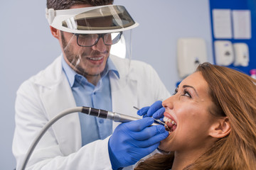 Dentist examining a patient's teeth in the dental office