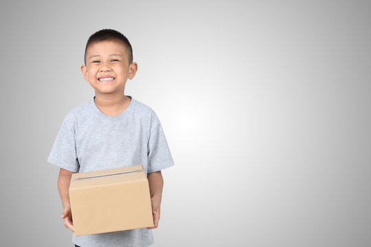 Asian kid holding empty cardboard box isolated on white background