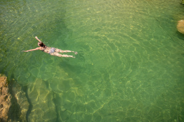 swimming in natural pool 