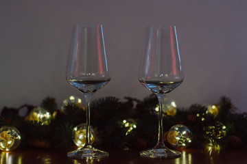 Christmas decoration with two glasses  and lights on a wooden background, Happy New Year. 