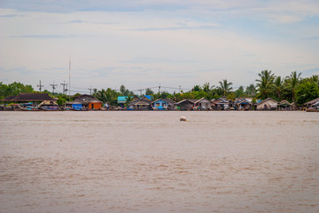 Fototapeta na wymiar Fishing boats and houses over the Krabi river