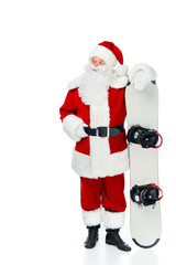 confident Santa claus standing with snowboard isolated on white