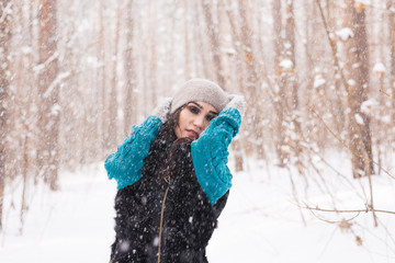 Fototapeta premium Happy young woman walking in winter time. Pretty girl in snowy nature