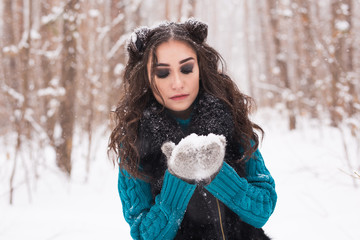 Christmas, holidays and season concept - Young beautiful smiling woman holding snow in hands in...