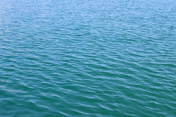 Green blue sea ocean water surface texture ripples abstract background light reflection