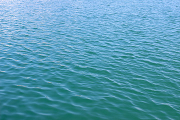 Green blue sea ocean water surface texture ripples abstract background light reflection