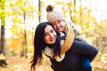 Fototapeta premium A Happy family on autumn, Mother and daughter in the Park