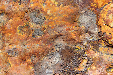 Rusted corroded yellow metal cast iron surface texture close up detail