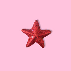 Red glitter shiny star on pink background for new year and christmas background, Minimal Concept