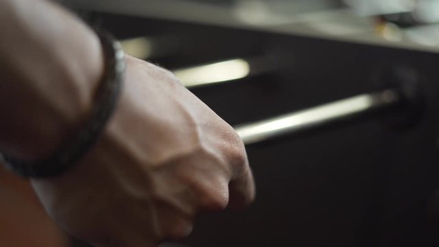 Closeup of a Man Playing Foosball in Real Time