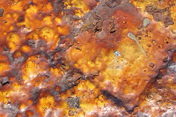Obraz na płótnie Canvas Heavily rusted corroded yellow painted metal cast iron triangular shape surface texture close up detail