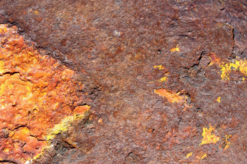 Heavily rusted yellow painted metal cast iron surface texture close up detail