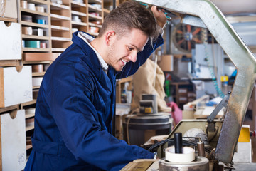 Working man practising skills with trimming machine