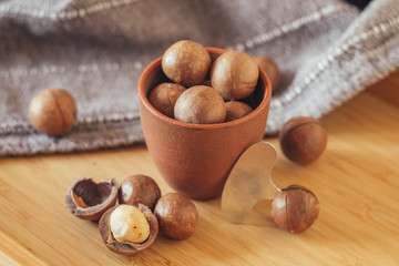 Close up Macadamia nuts on wooden background, superfood and healthy food