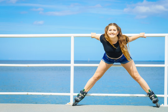 Girl wearing roller skates on seaside