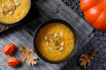 Autumn still life with pumpkin cream soup and vegetables.
