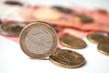 closeup of euro coins and bank notes on white background