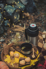Autumn picnic by the fire in nature: coffee pot, waffles, fire, stylishly served in the style of hugge.