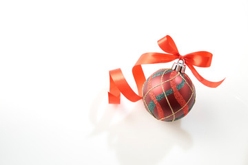 Christmas ball with red bow on white