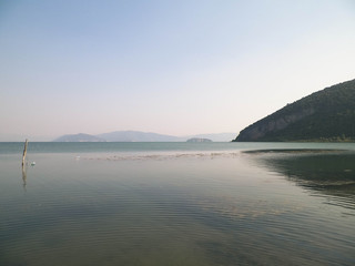 Coast of Lake Prespa and Mountains of Galicica National Park.