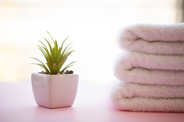 Spa. White Cotton Towels Use In Spa Bathroom on Pink Background. Towel Concept. Photo For Hotels and Massage Parlors. Purity and Softness. Towel Textile