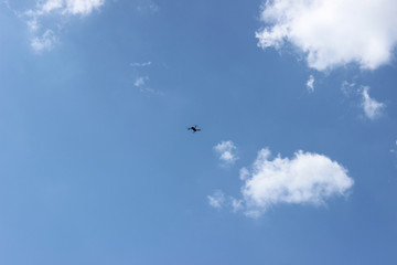 Drone uav flying surveillance security spy hobby recording background small far motion center clear blue noon sky clouds