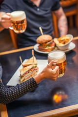 people eating and drinking in american restaurant, beer, hamburger, wine and other american specialites