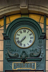 View of classic retro wall clock at the train station of St. Bento in Porto city