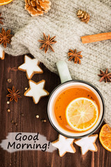 Obraz na płótnie Canvas Winter theme. Hot tea with spices, orange,cinnamon,anise,cookies