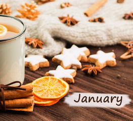 Winter theme. Cup of hot tea with spices, orange, cinnamon, anis