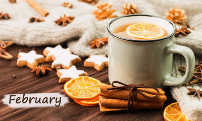 Winter theme. Cup of hot tea with spices, orange, cinnamon, anis