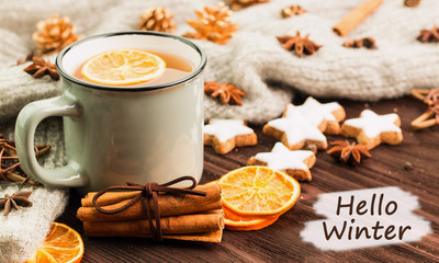 Winter theme. Cup of hot tea with spices, orange, cinnamon, anis