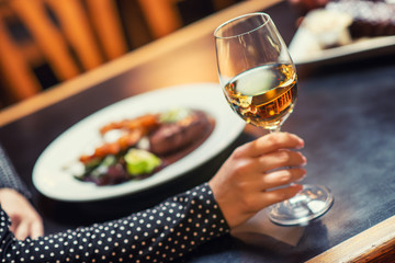 people eating and drinking in american restaurant, beer, hamburger, wine and other american specialites