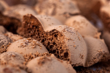 Broken milky porous chocolate, sweets and desserts