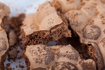 Broken milky porous chocolate, sweets and desserts