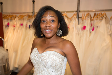 Bride african american black is choosing a dress at the clothes shop for wedding dresses