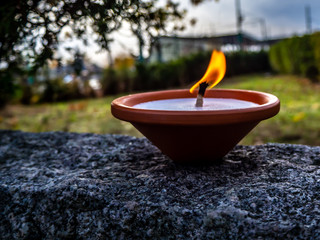 Candle on a stone wall