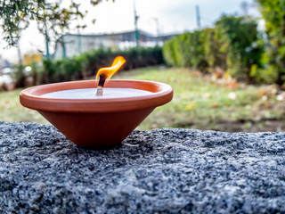 Candle on a stone wall