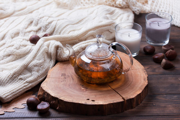 Autumn leaves and cup of tea on wooden table