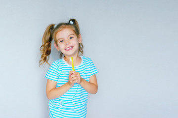 Beautiful baby girl brushing her teeth. Baby girl brushing her teeth and singing a favorite song.  Health care, dental hygiene, people and beauty concept. Mockup, free spase. Selective focus. 