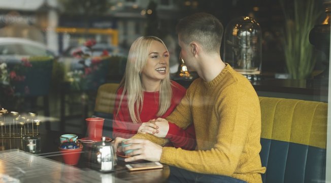 Couple interacting with each other in cafeteria