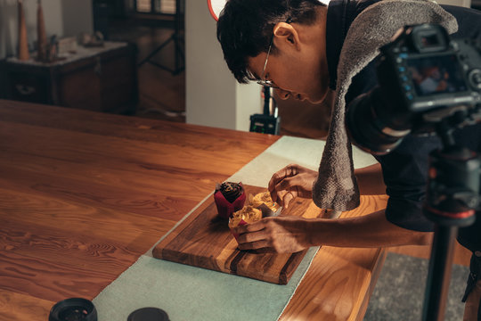 Photographer arranging food for photography vlog