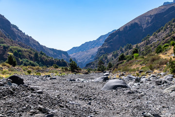 Dried river bed at Barranco de las Angustias, looking away from the main volcanic crater in Caldera de Taburiente National Park, La Palma, Canary Island, Spain