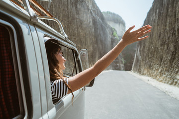 young woman on road trip on the beach