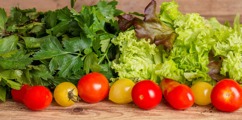 Red and yellow tomatoes, fragrant herbs and lettuce leaves