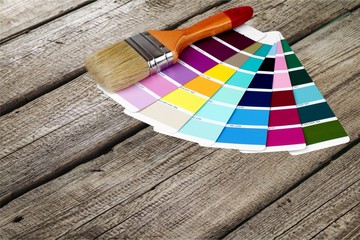 Brush and bright palette of colors isolated on background