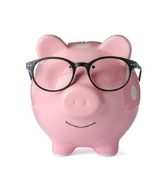 Piggy bank with glasses isolated on white